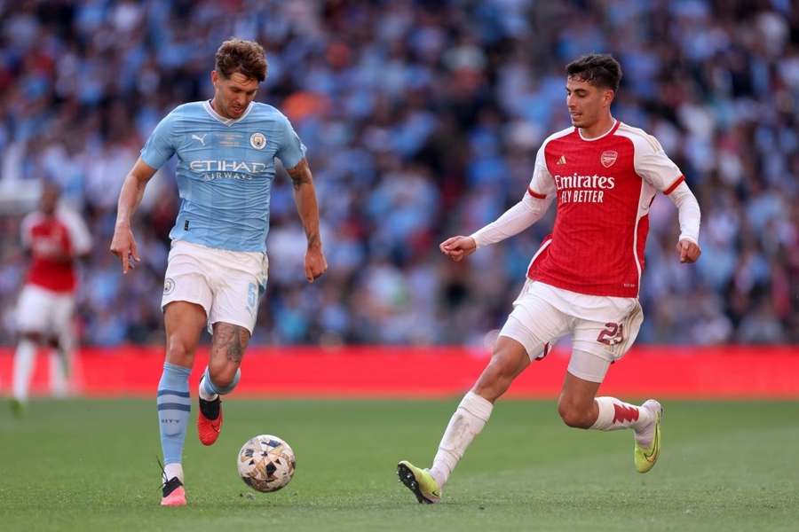 Stones' 98th minute equaliser stuns 10-man Arsenal as Man City salvage draw